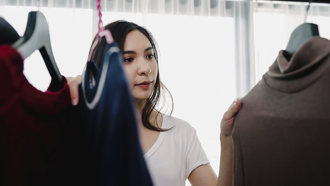 A women looking at clothes on a cloting rack