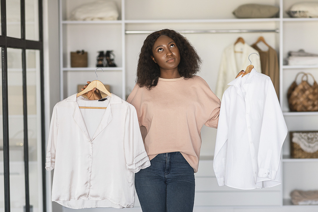 A women mentally comparing two blouses