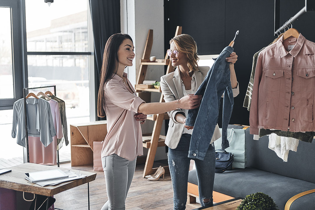 Two friends browsing new clothes together