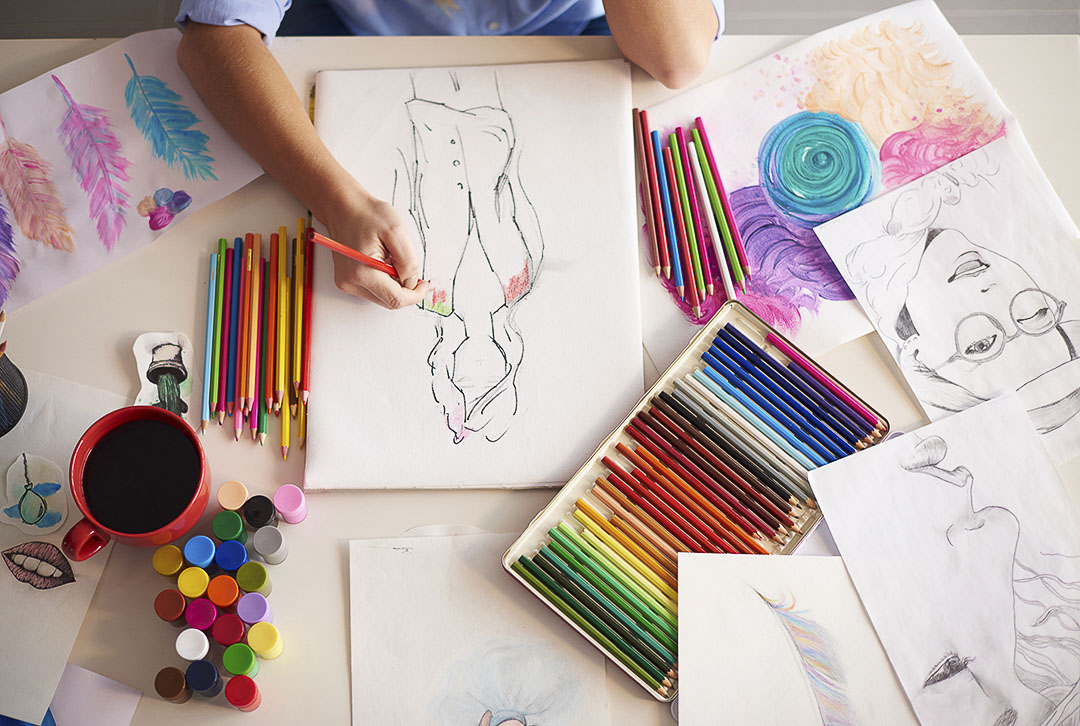 a women drawing in her sketch book