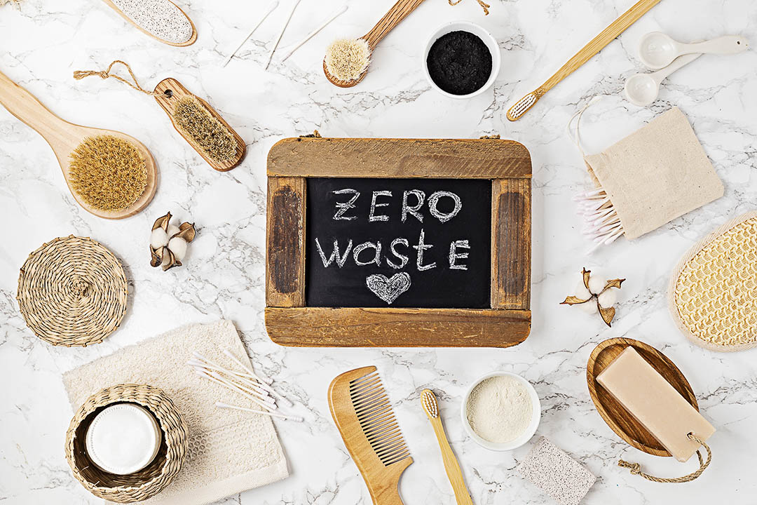 a blackboard with zero waste on it and a dozen sustainable products around