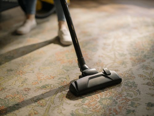 a rug being vacuumed